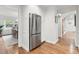 Kitchen featuring stainless steel refrigerator and hardwood flooring adjacent to dining area at 5061 S Florence Dr, Englewood, CO 80111