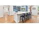 Spacious kitchen featuring an island with bar seating, modern lighting, and stainless steel appliances at 5061 S Florence Dr, Englewood, CO 80111