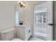 Bright bathroom with a large mirror, sleek fixtures, and a view into an adjacent bedroom at 348 N. Geneva St, Aurora, CO 80010