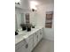 Bright bathroom featuring double vanity with white cabinets and stone countertop at 348 N. Geneva St, Aurora, CO 80010