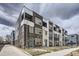 Modern townhome exterior featuring brick facade, white accents, and individual balconies at 348 N. Geneva St, Aurora, CO 80010