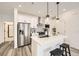 Contemporary kitchen with stainless steel appliances, a quartz countertop island, and stylish pendant lighting at 348 N. Geneva St, Aurora, CO 80010