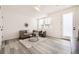 Bright living room with modern gray sofa, chair, and stylish decor on light wood floor at 348 N. Geneva St, Aurora, CO 80010