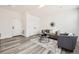 Comfortable living room with modern gray furnishings, sleek décor and wood-look floors at 348 N. Geneva St, Aurora, CO 80010
