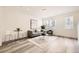 Inviting living room featuring a neutral color scheme, large windows, and modern decor, perfect for relaxation and entertainment at 348 N. Geneva St, Aurora, CO 80010