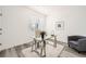 Bright office featuring a glass desk, neutral chair, and minimalist decor on wood floor at 348 N. Geneva St, Aurora, CO 80010