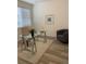 Bright home office with large window, glass desk, tufted chair and gray accent chair at 348 N. Geneva St, Aurora, CO 80010