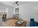 Open floor plan with dining table, wicker chairs and hard wood floors at 1629 N Clarkson St # 13, Denver, CO 80218