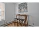 Dining area with wooden table, stools, and tree-themed painting with natural light at 1629 N Clarkson St # 13, Denver, CO 80218