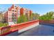 Building exterior, showing balconies, landscaping, and surrounding trees at 1629 N Clarkson St # 13, Denver, CO 80218