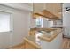 Efficient kitchen with stainless steel sink, blonde wood cabinets, and access to outside door at 1629 N Clarkson St # 13, Denver, CO 80218