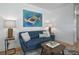 Living room boasts stylish blue sofa, modern art, and wood laminate flooring at 1629 N Clarkson St # 13, Denver, CO 80218