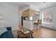 Bright living room with breakfast bar, wood floors, and view of the kitchen area at 1629 N Clarkson St # 13, Denver, CO 80218