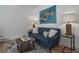 Cozy living room featuring a blue sofa, decorative pillows, and a wood floor at 1629 N Clarkson St # 13, Denver, CO 80218