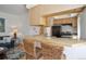 Cozy living space with breakfast bar, blonde wood cabinets, and view of living room at 1629 N Clarkson St # 13, Denver, CO 80218