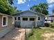 View of the exterior backyard of a blue home with green trees at 1738 Dallas St, Aurora, CO 80010