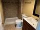 Bathroom featuring a tiled shower, toilet, and modern vanity with sink at 1738 Dallas St, Aurora, CO 80010