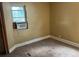 Carpeted bedroom featuring an AC unit in the window with natural light at 1738 Dallas St, Aurora, CO 80010