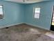Cozy carpeted bedroom with light blue walls and natural light from multiple windows at 1738 Dallas St, Aurora, CO 80010