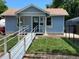 Charming single-story home featuring a ramp, blue siding, and well-maintained lawn at 1738 Dallas St, Aurora, CO 80010
