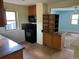 Functional kitchen with wooden cabinets, black appliances, and tile floor at 1738 Dallas St, Aurora, CO 80010