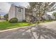 View of a condominium building featuring well-maintained grounds, muted gray exteriors and black iron staircases at 7165 S Gaylord St # E07, Centennial, CO 80122