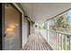 Charming balcony with a wood deck and white railings, perfect for enjoying outdoor views and fresh air at 921 S Walden Street # 205, Aurora, CO 80017