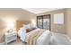 Serene bedroom featuring a comfortable bed, neutral decor, and private balcony access at 921 S Walden Street # 205, Aurora, CO 80017