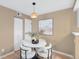 Bright dining area features a modern pendant light, stylish table setting, and easy access to nearby amenities at 921 S Walden Street # 205, Aurora, CO 80017