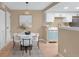 Charming dining area boasts a pendant light, white table with seating, and opens to the kitchen at 921 S Walden Street # 205, Aurora, CO 80017