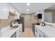 Modern kitchen with white cabinets, sleek countertops, stainless steel appliances, and efficient layout at 921 S Walden Street # 205, Aurora, CO 80017