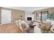 Inviting living room with a stone fireplace, stylish seating, and sliding glass doors to balcony at 921 S Walden Street # 205, Aurora, CO 80017