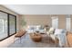 Bright living room featuring a modern design, balcony access, and neutral color palette at 921 S Walden Street # 205, Aurora, CO 80017