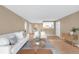 Open floor plan showcases a seamlessly integrated living and dining area with modern decor and wood flooring at 921 S Walden Street # 205, Aurora, CO 80017