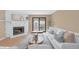 Cozy living room with a white stone fireplace, access to the balcony, and a modern design at 921 S Walden Street # 205, Aurora, CO 80017