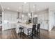 Modern kitchen with white cabinets, quartz countertops, pendant lighting, and stainless steel appliances at 3093 Belay Pt, Castle Rock, CO 80108