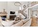 Spacious living room with high ceilings, fireplace, staircase, and modern decor at 3093 Belay Pt, Castle Rock, CO 80108