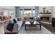 Bright living room featuring a fireplace, large windows, and a comfortable sectional sofa at 3093 Belay Pt, Castle Rock, CO 80108
