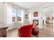 Cozy sitting area with red armchair and built-in fireplace at 3093 Belay Pt, Castle Rock, CO 80108