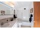 Bright bathroom featuring a classic white tub, white tile and marble countertop sink at 660 S Alton Way # 12C, Denver, CO 80247
