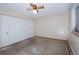 Bedroom featuring a ceiling fan and spacious closet with white doors at 660 S Alton Way # 12C, Denver, CO 80247