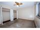Bedroom featuring a ceiling fan and spacious closet with folding doors at 660 S Alton Way # 12C, Denver, CO 80247