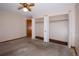 Bedroom featuring a ceiling fan, spacious closet, and exterior door at 660 S Alton Way # 12C, Denver, CO 80247