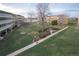 Expansive complex common area with lush green grass, mature trees, and walking paths at 660 S Alton Way # 12C, Denver, CO 80247