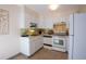Bright kitchen features white cabinetry and appliances at 660 S Alton Way # 12C, Denver, CO 80247