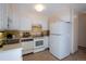 Kitchen features white appliances and cabinets at 660 S Alton Way # 12C, Denver, CO 80247
