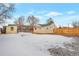 Large backyard with wooden fence and detached garage at 6900 E 66Th Ave, Commerce City, CO 80022