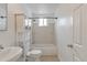 Neat bathroom with a toilet, cabinet, shower and tub combination, and updated fixtures at 6900 E 66Th Ave, Commerce City, CO 80022