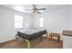 Comfortable bedroom features ample light from two windows, neutral walls and carpet at 6900 E 66Th Ave, Commerce City, CO 80022