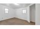 Cozy bedroom with neutral carpet, white walls, closet space, and two bright windows at 6900 E 66Th Ave, Commerce City, CO 80022